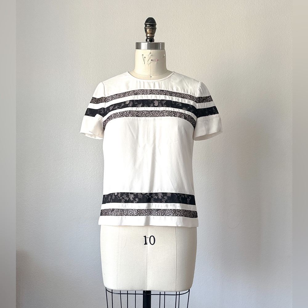 BCBG White short sleeve blouse with black lace trim.